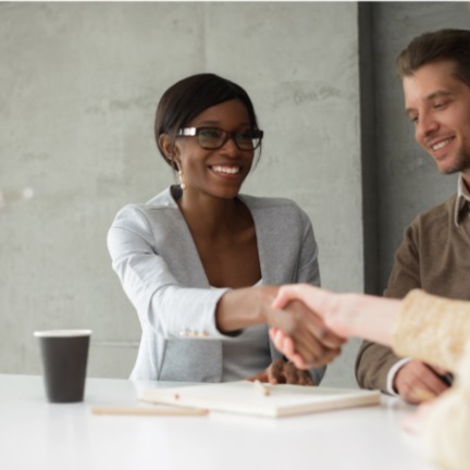 Professional shaking hands illustrates the work Confero does in the banking and financial industries providing customer experience research services.