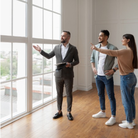 Real estate agent showing apartment to prospective renters is an illustration of the customer experience research options that Confero offers in housing and real estate industries.