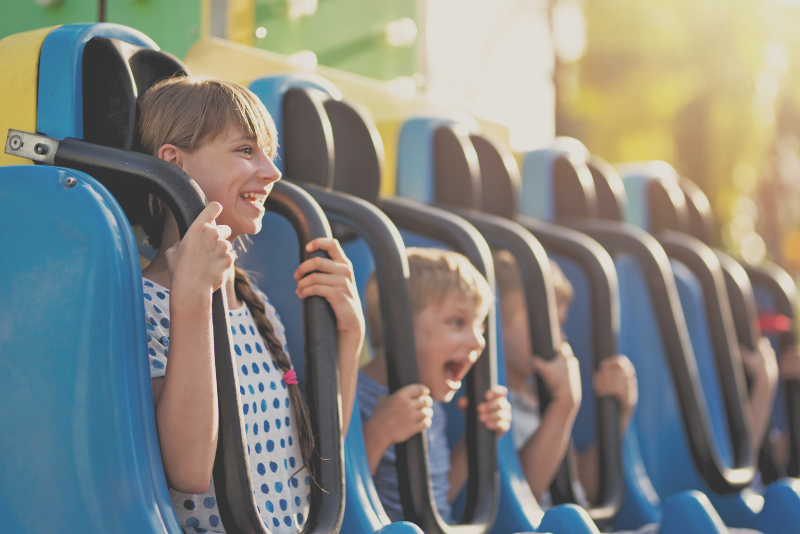 Amusement park rider smiling to illustrate Confero's customer experience research in the amusement park industry.