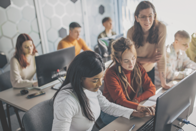 Classroom scene with engaged pupils and teacher to illustrate Confero's customer experience research services in education and campus industries.