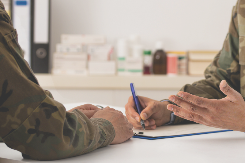 Uniformed arms at a service counter to illustrate Confero's customer experience research in governmental and regulatory industries.