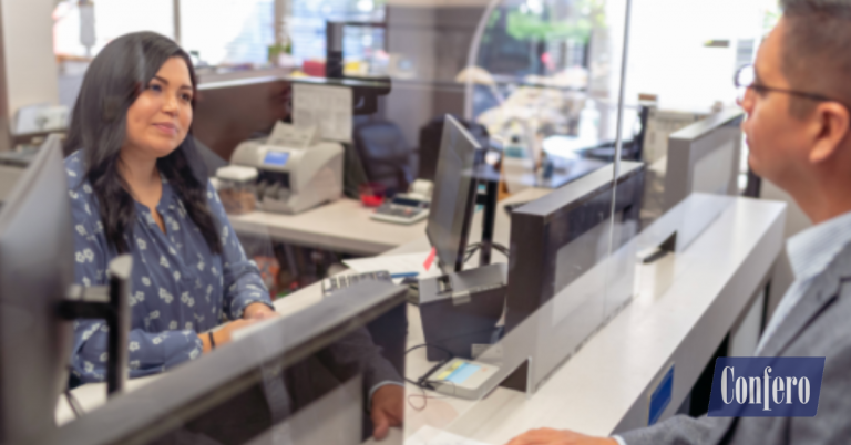 Bank teller greeting a customer by name and offering additional services — banking mystery shopping case study, Confero.
