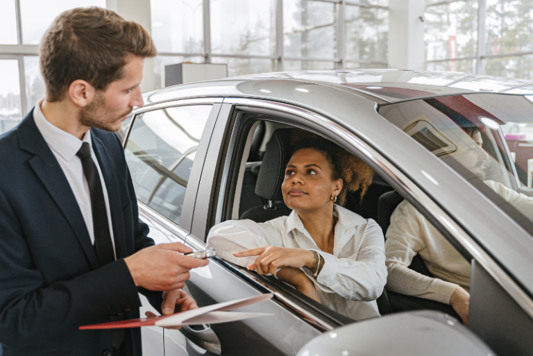 Confero case study details auditor reviewing point-of-purchase materials in auto dealership.